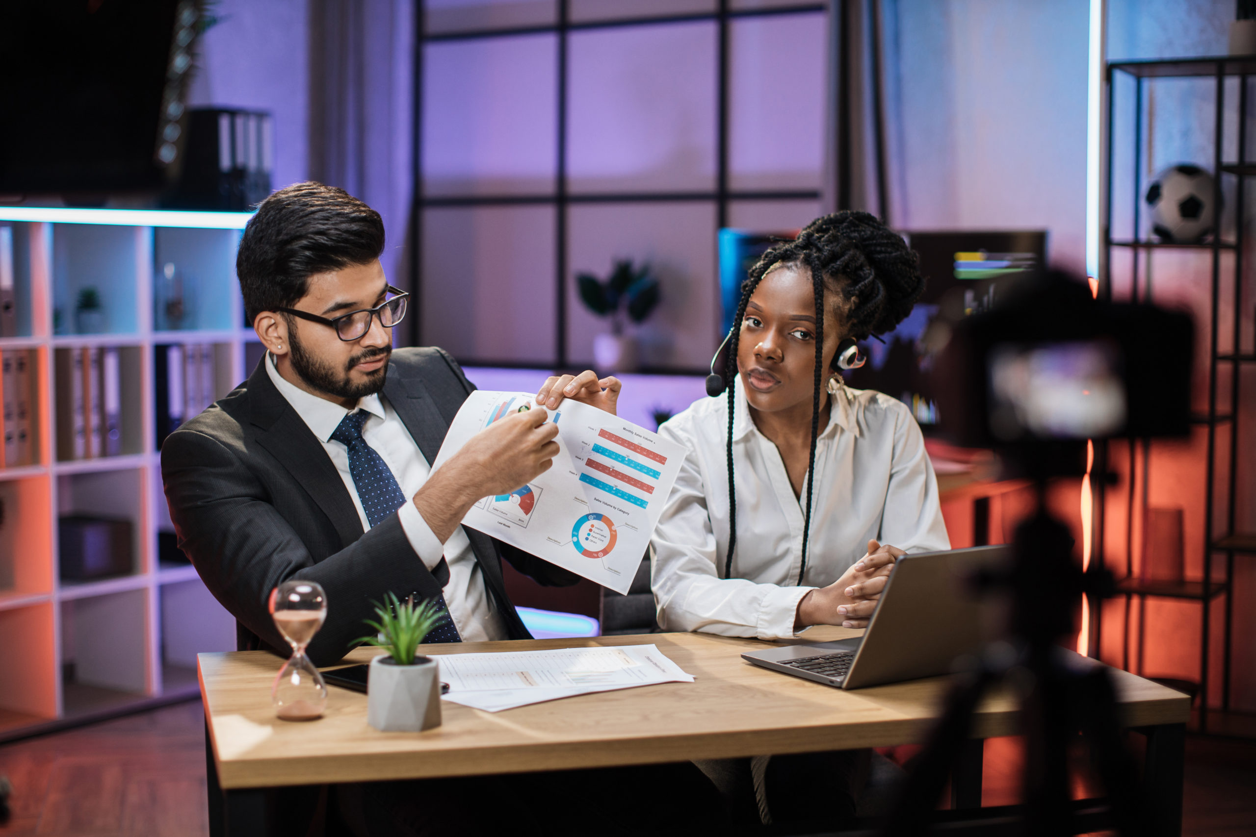 Arab businessman or broker in formal suit and his colleague African American woman