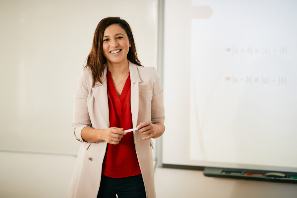 Portrait of happy professor teaching
